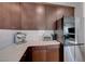 Elegant kitchen featuring wood cabinets, stainless steel appliances, and bright countertops at 2685 Conifer Canyon St, Henderson, NV 89044