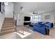 Bright and open living room with modern decor, stairs, and large windows offering ample natural light at 2685 Conifer Canyon St, Henderson, NV 89044