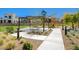 Community playground featuring a picnic bench beneath a pergola and modern play equipment at 2685 Conifer Canyon St, Henderson, NV 89044