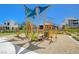 Community playground with modern play structure set against a backdrop of residential buildings at 2685 Conifer Canyon St, Henderson, NV 89044