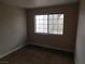 This bedroom has a window that lets in sunlight, neutral colored walls, and carpeting at 2750 S Durango Dr # 2072, Las Vegas, NV 89117