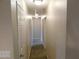 Hallway with neutral walls, multiple doors, and overhead lighting at 2750 S Durango Dr # 2072, Las Vegas, NV 89117