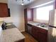 Functional kitchen with granite countertops, stainless steel appliances, and wood-look laminate floors at 2750 S Durango Dr # 2072, Las Vegas, NV 89117