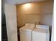 Convenient laundry area with full-size washer and dryer and storage shelves at 2750 S Durango Dr # 2072, Las Vegas, NV 89117