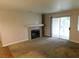 Cozy living room featuring a fireplace, built-in shelves, and a sliding door to the balcony at 2750 S Durango Dr # 2072, Las Vegas, NV 89117