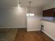 An open concept living room and dining area, featuring modern lighting and flooring at 2750 S Durango Dr # 2072, Las Vegas, NV 89117