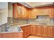 Kitchen area with wood cabinetry, granite countertops, and stainless steel sink at 2777 Paradise Rd # 607, Las Vegas, NV 89109