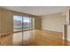 Living room with hardwood floors, balcony, and city views through large windows at 2777 Paradise Rd # 607, Las Vegas, NV 89109