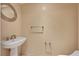 Tastefully designed powder room with a pedestal sink and elegant fixtures at 2777 Paradise Rd # 607, Las Vegas, NV 89109