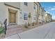 A modern townhome exterior with brick steps leading to a front door at 2949 White Selzter Ct, Las Vegas, NV 89122