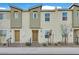 Newly constructed townhomes with neutral exteriors, desert landscaping, and private entrances at 2949 White Selzter Ct, Las Vegas, NV 89122