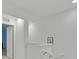Bright hallway features white walls and a staircase leading to the upper level, enhanced by natural light and simple decor at 2949 White Selzter Ct, Las Vegas, NV 89122