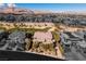 Aerial view of estate with landscaped yard surrounded by community and mountain views at 30 Meadowhawk Ln, Las Vegas, NV 89135
