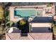 Aerial view showcasing a large rectangular pool, spa, putting green and the home's tile roof at 30 Meadowhawk Ln, Las Vegas, NV 89135