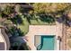 Aerial view showcasing a putting green, outdoor pool, covered patio, and the home's landscaping at 30 Meadowhawk Ln, Las Vegas, NV 89135