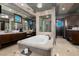 Luxurious bathroom featuring a soaking tub, elegant vanities, and a spacious glass-enclosed shower at 30 Meadowhawk Ln, Las Vegas, NV 89135
