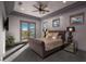 Beautiful bedroom featuring tray ceiling, private balcony, plush carpet, and stylish bedside lamps at 30 Meadowhawk Ln, Las Vegas, NV 89135
