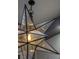 Modern star shaped hanging chandelier with exposed bulb lighting fixtures at 30 Meadowhawk Ln, Las Vegas, NV 89135