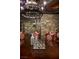 Elegant dining room showcasing stone walls, wooden table setting, and a unique chandelier at 30 Meadowhawk Ln, Las Vegas, NV 89135