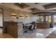 Elegant dining room with stone accent wall, modern lighting, and stylish seating for a luxurious dining experience at 30 Meadowhawk Ln, Las Vegas, NV 89135