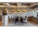 Elegant dining room with stone accent wall, modern lighting, and stylish seating for a luxurious dining experience at 30 Meadowhawk Ln, Las Vegas, NV 89135