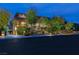 Beautifully landscaped property with manicured gardens and a lighted driveway, creating an inviting entrance at 30 Meadowhawk Ln, Las Vegas, NV 89135