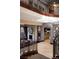 Elegant foyer showcasing a split staircase and a view of the formal living room with stone fireplace at 30 Meadowhawk Ln, Las Vegas, NV 89135