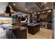 A well-appointed kitchen with multiple islands and stainless steel appliances, flowing into an inviting living space at 30 Meadowhawk Ln, Las Vegas, NV 89135