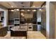 An open concept gourmet kitchen with a large island, stainless steel appliances, and pendant lighting at 30 Meadowhawk Ln, Las Vegas, NV 89135