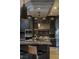 A spacious kitchen with granite countertops, custom cabinets, stainless steel appliances and modern decorative lighting at 30 Meadowhawk Ln, Las Vegas, NV 89135