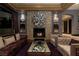 Elegant living room with stone fireplace, unique wall art, and comfortable seating at 30 Meadowhawk Ln, Las Vegas, NV 89135