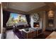 Beautiful living room with stone fireplace, modern decor, and a view of the backyard at 30 Meadowhawk Ln, Las Vegas, NV 89135