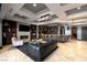 Spacious living room with fireplace, open kitchen, and modern lighting fixtures at 30 Meadowhawk Ln, Las Vegas, NV 89135