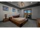 Main bedroom with hardwood bed frame, gray walls, a tray ceiling, and a balcony with mountain views at 30 Meadowhawk Ln, Las Vegas, NV 89135