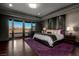 Luxurious main bedroom with balcony access, plush bedding, and stylish furnishings for a relaxing retreat at 30 Meadowhawk Ln, Las Vegas, NV 89135