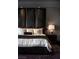 Elegant main bedroom featuring a padded headboard, plush bedding, and sophisticated decor at 30 Meadowhawk Ln, Las Vegas, NV 89135