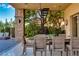 Elegant outdoor dining area with a spiral staircase and lush greenery at 30 Meadowhawk Ln, Las Vegas, NV 89135