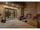Cozy outdoor living area with a stone fireplace and comfortable seating at 30 Meadowhawk Ln, Las Vegas, NV 89135