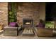 Inviting outdoor fireplace with comfortable seating and a rustic wooden table at 30 Meadowhawk Ln, Las Vegas, NV 89135
