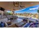 Expansive outdoor kitchen and dining area with stunning views and comfortable seating at 30 Meadowhawk Ln, Las Vegas, NV 89135