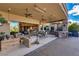 Spacious outdoor patio with comfortable seating, ceiling fans, barbecue, and an open view to the interior living space at 30 Meadowhawk Ln, Las Vegas, NV 89135
