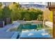 Luxurious pool area with lounge chairs and lush landscaping at 30 Meadowhawk Ln, Las Vegas, NV 89135