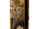 Stone wall inside stairwell featuring a pendant light, which complements stone walls at 30 Meadowhawk Ln, Las Vegas, NV 89135
