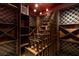 A custom wine cellar featuring unique wooden shelving and climate control system at 30 Meadowhawk Ln, Las Vegas, NV 89135