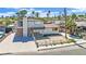 Two-story home needing repair, featuring a brick chimney, front yard with a chain link fence, and a concrete driveway at 3009 Merritt Ave, Las Vegas, NV 89102