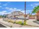 Two-story home with mixed brick and siding exterior and front yard needing revitalization at 3009 Merritt Ave, Las Vegas, NV 89102
