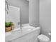 Cozy powder room with modern fixtures, white vanity, and decorative accents at 3192 Timorasso Ave, Henderson, NV 89044