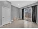 Clean, bright room featuring tile flooring, a sliding glass door, and neutral decor at 3192 Timorasso Ave, Henderson, NV 89044