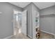 Hallway view of closet showing shelving and door with neutral carpet at 3192 Timorasso Ave, Henderson, NV 89044