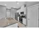 Modern kitchen featuring stainless steel appliances, granite countertops, and white cabinets at 3192 Timorasso Ave, Henderson, NV 89044